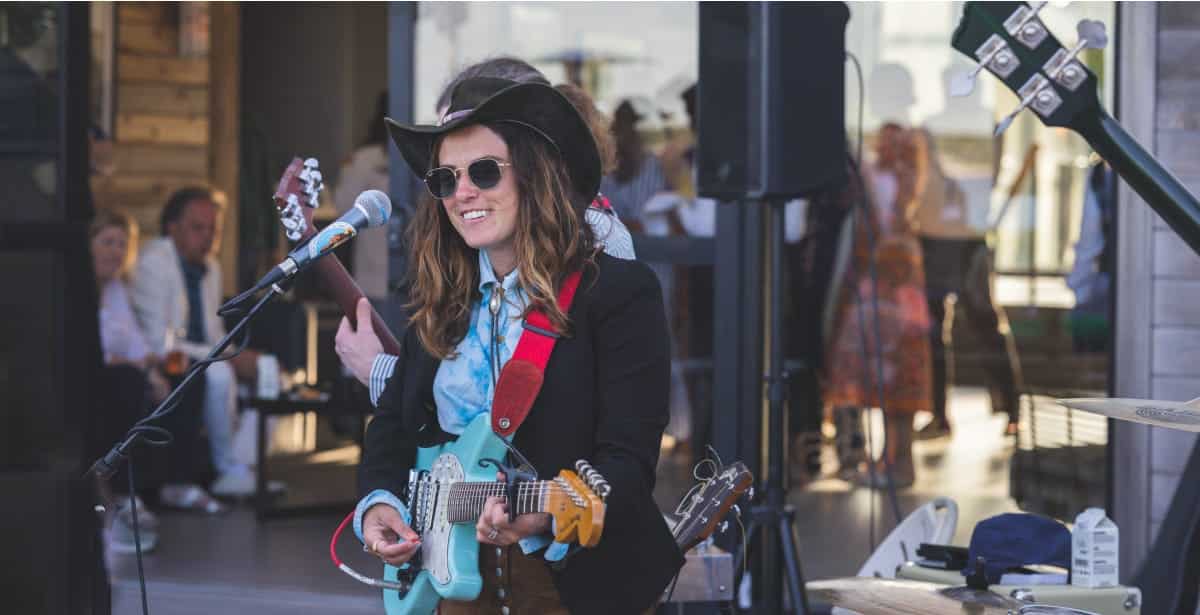 girl playing guitar on stage