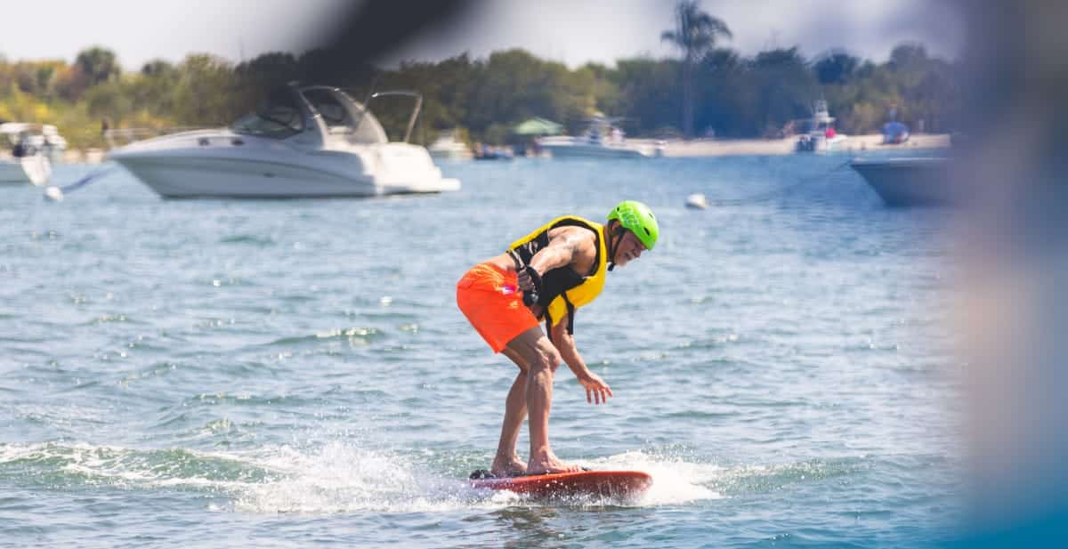 man surfing in orange shorts