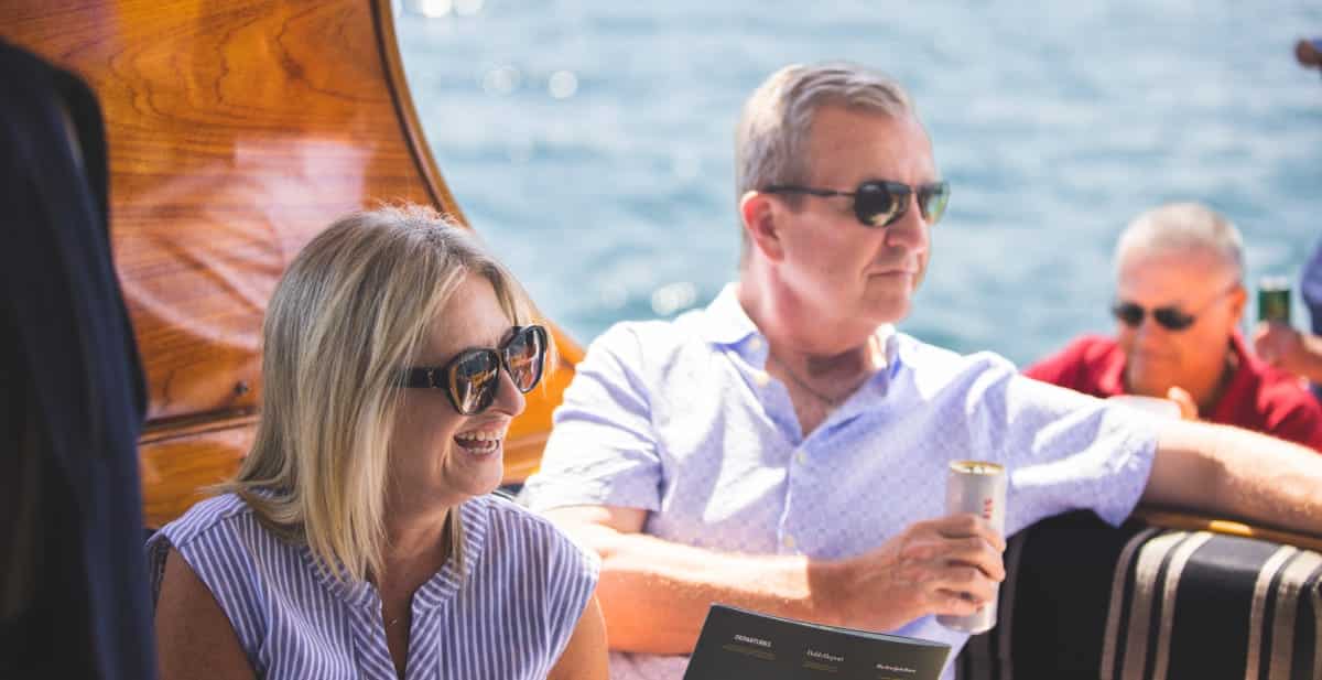 a woman and man sitting on a boat